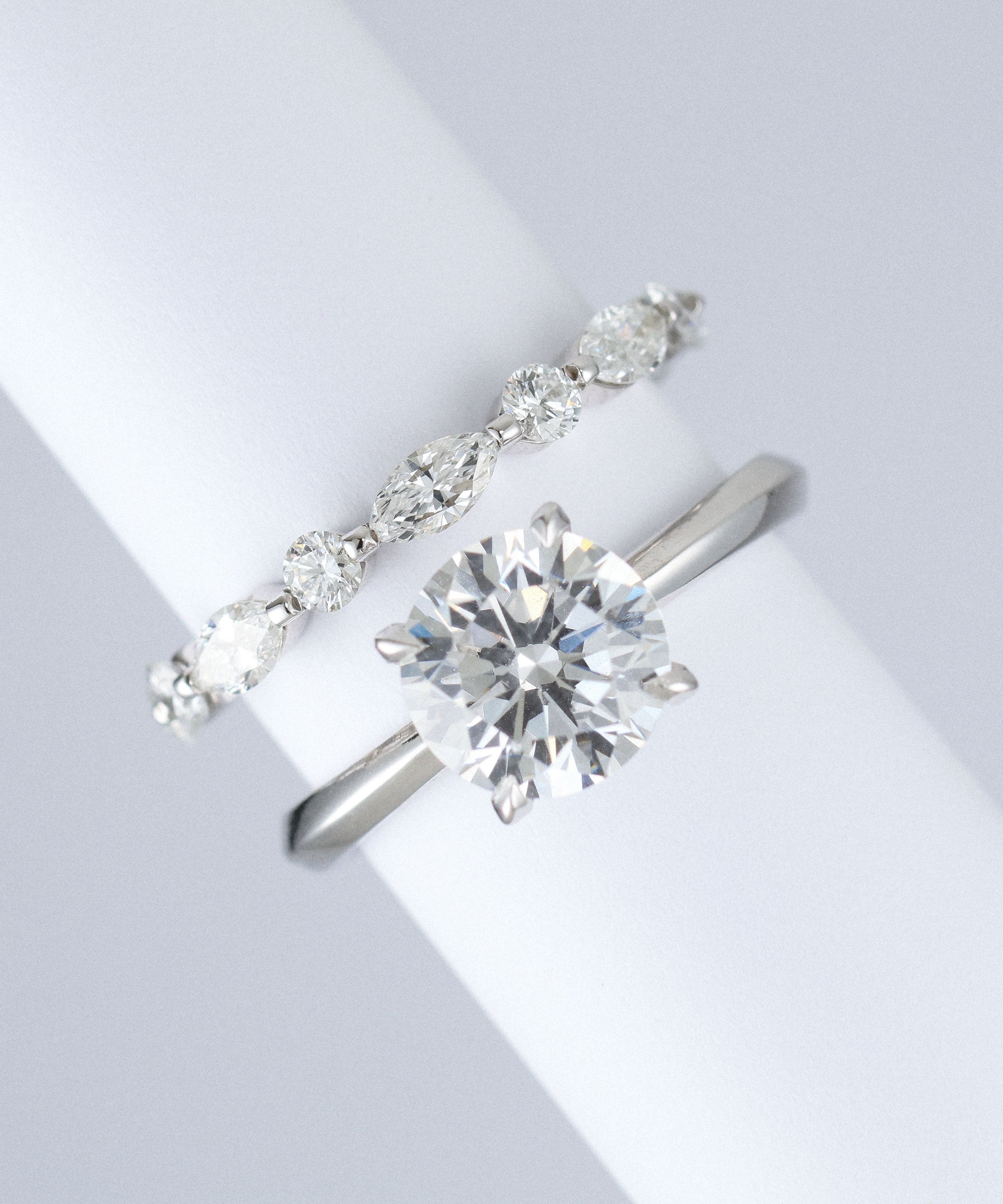marquise and round lab grown diamond wedding band in platinum next to engagement ring
