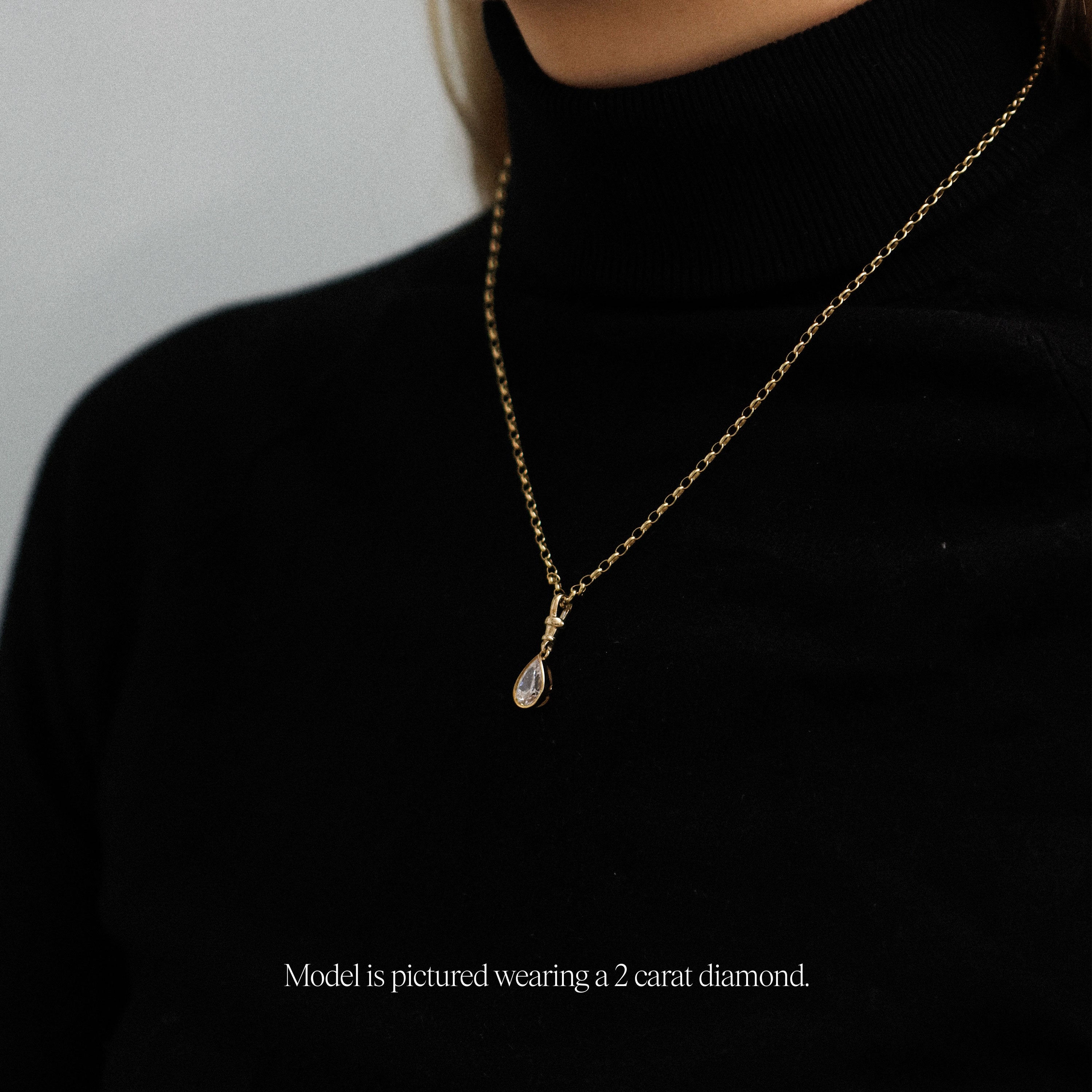 model wearing a 2 carat lab grown diamond pear shaped yellow gold vintage inspired diamond pendant