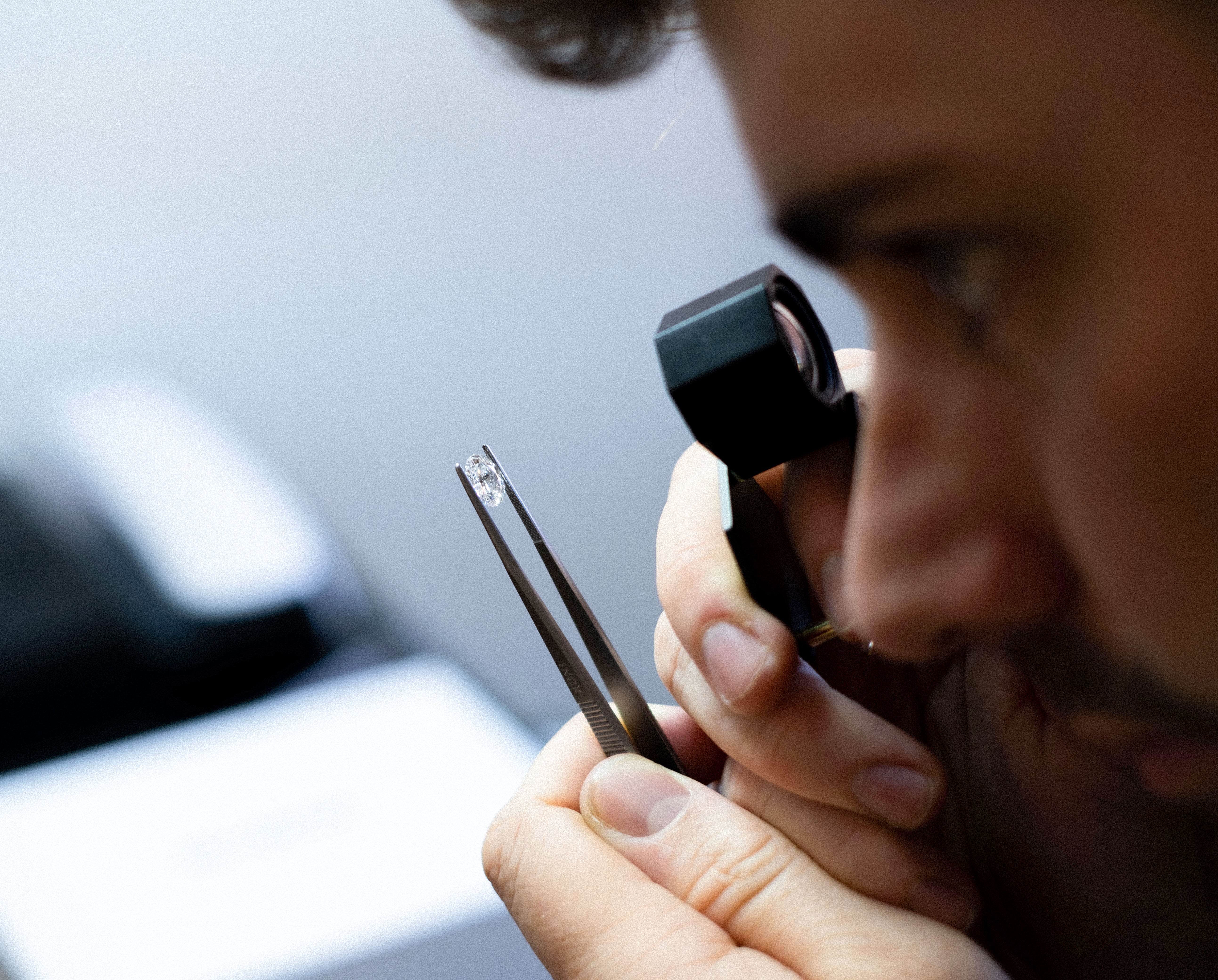 Harry looking at oval lab grown diamond. This stone was used to make an oval engagement ring