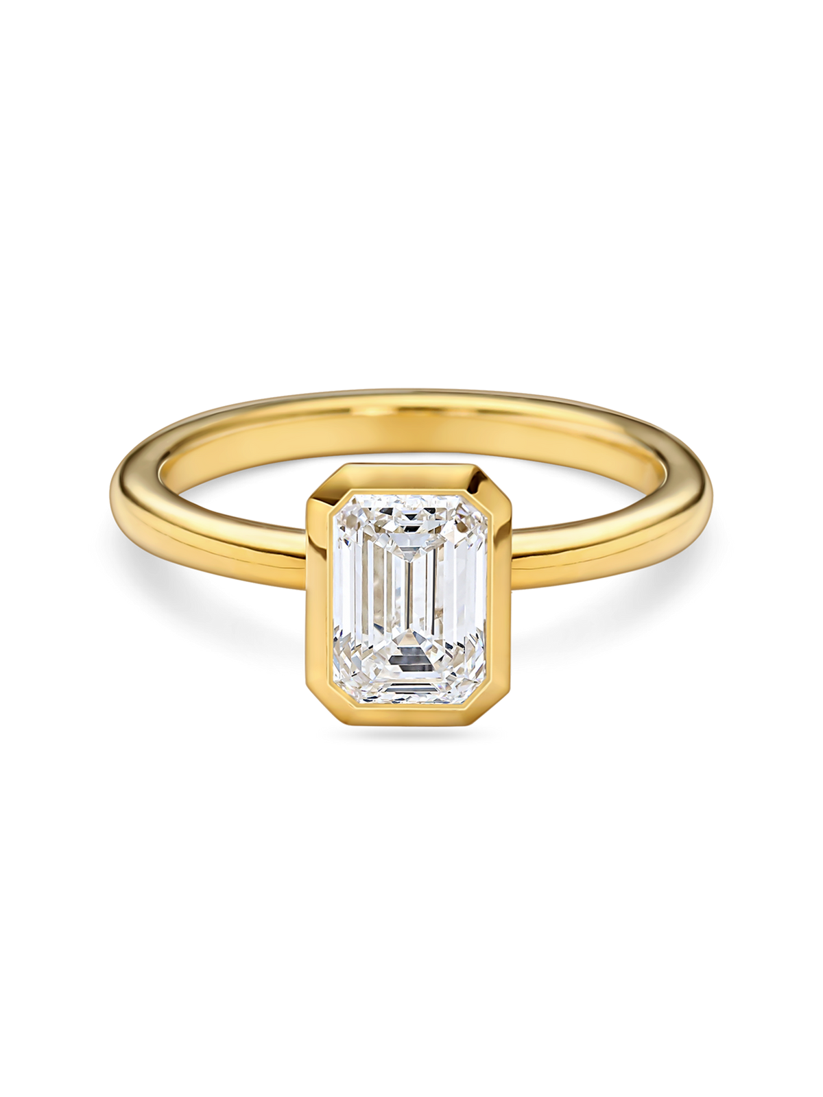 Emerald cut lab grown diamond in a yellow gold bezel setting