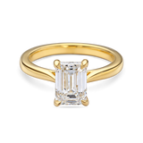 front view of yellow gold lab grown emerald cut solitaire engagement ring with cathedral setting. 2 carat