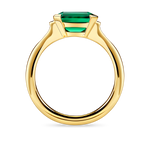 Side view of lab created emerald ring with east west setting and gold band
