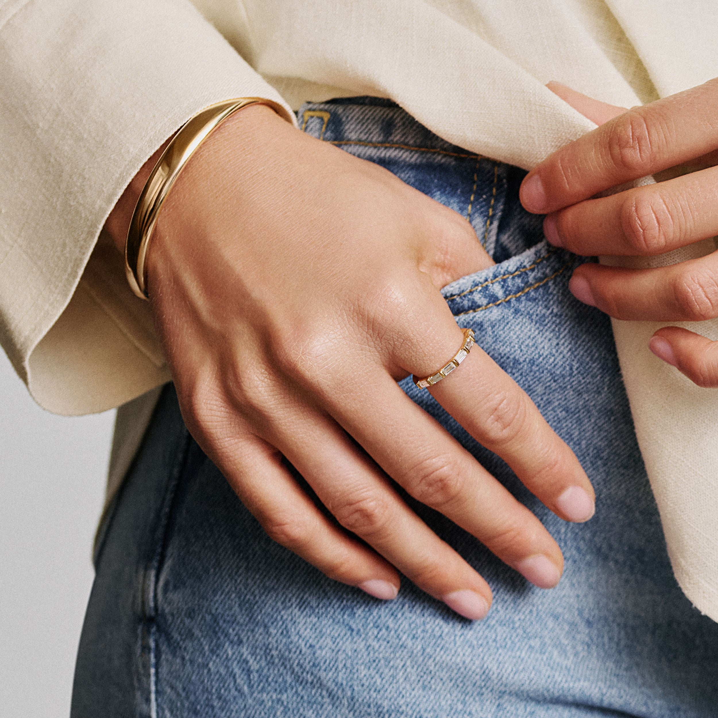 model wearing yellow baguette diamond eternity ring/ wedding band made with lab grown diamonds