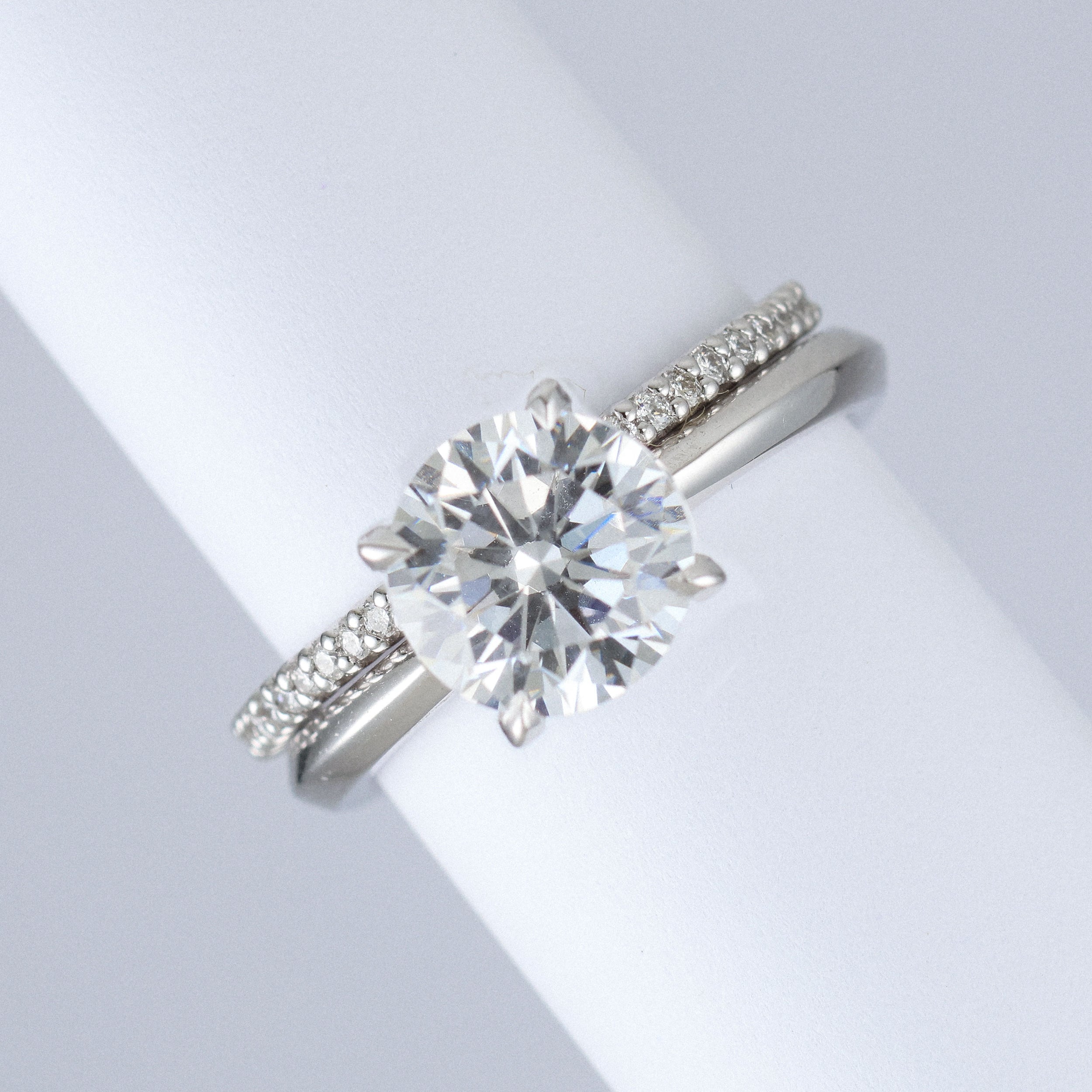 cut down eternity ring in platinum featuring lab grown diamonds. Half set with engagement ring