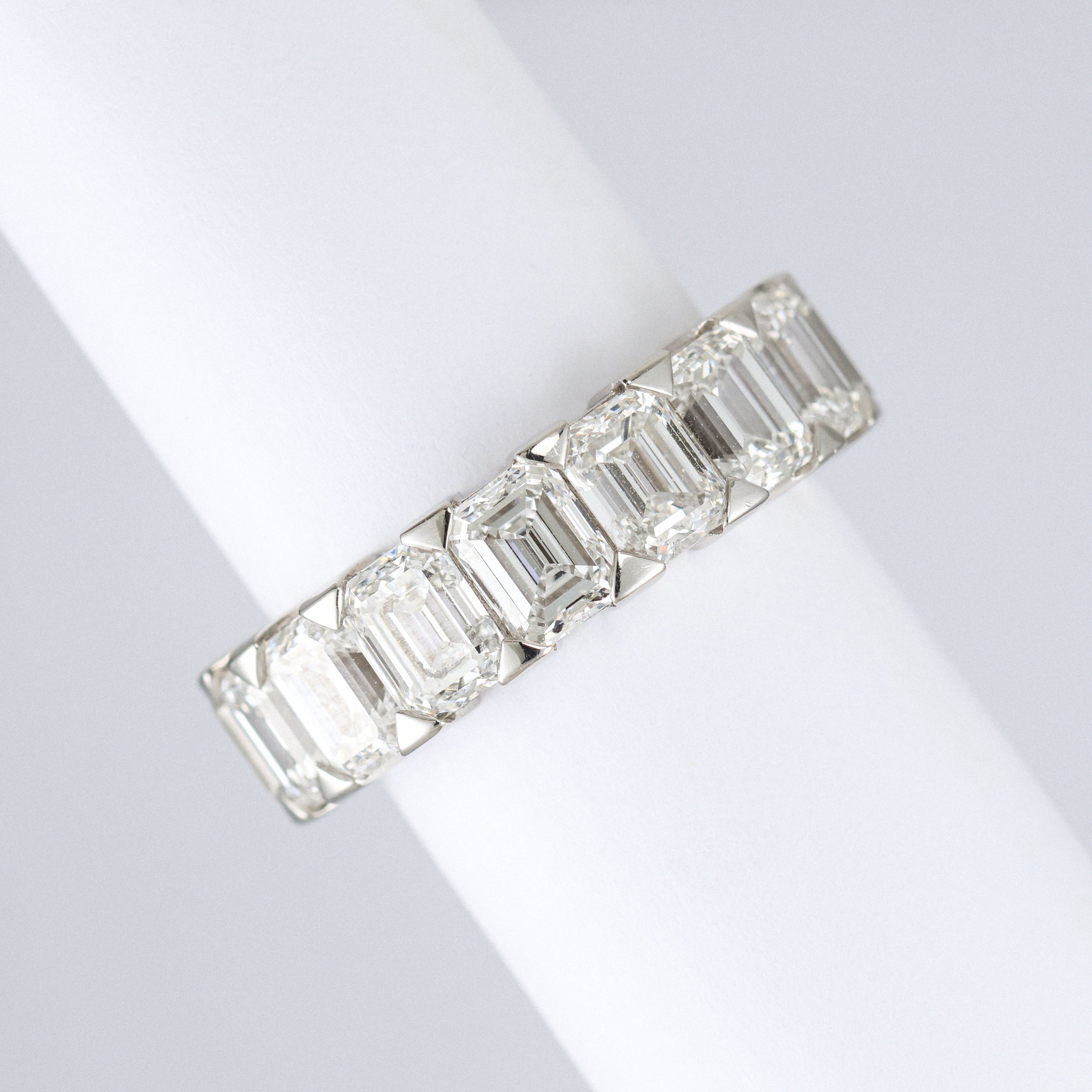 platinum emerald cut lab grown diamond eternity ring on scroll