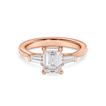 front view of emerald cut trilogy engagement ring in rose gold. features lab grown diamond