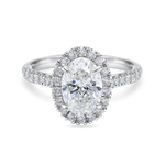 Beautiful lab grown oval halo engagement ring with diamond set band. Platinum band, front view