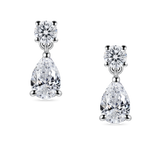 close up of lab grown diamond drop earrings. Round and pear diamond earrings in platinum, on model. 2 carats total weight