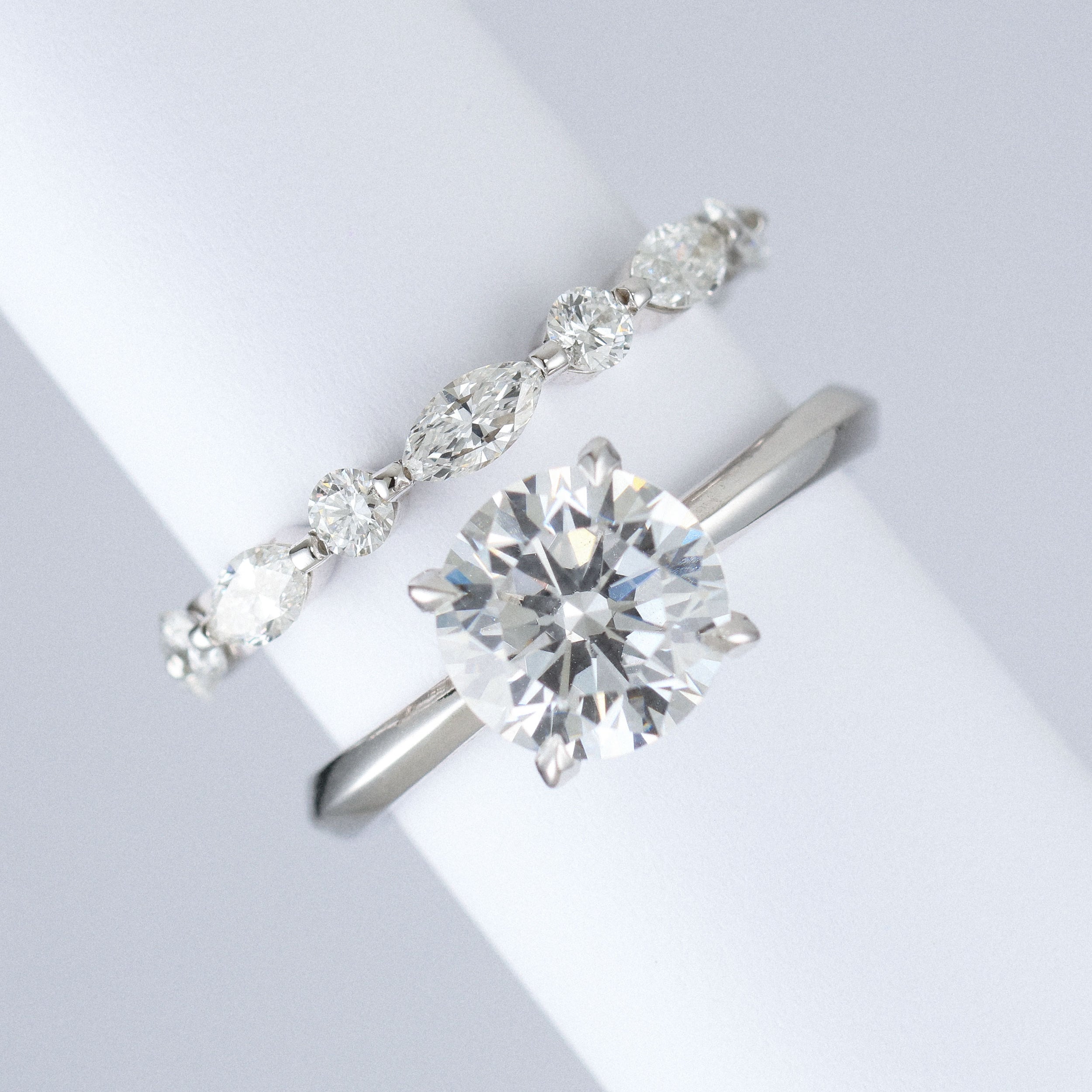 marquise and round lab grown diamond wedding band in platinum next to engagement ring