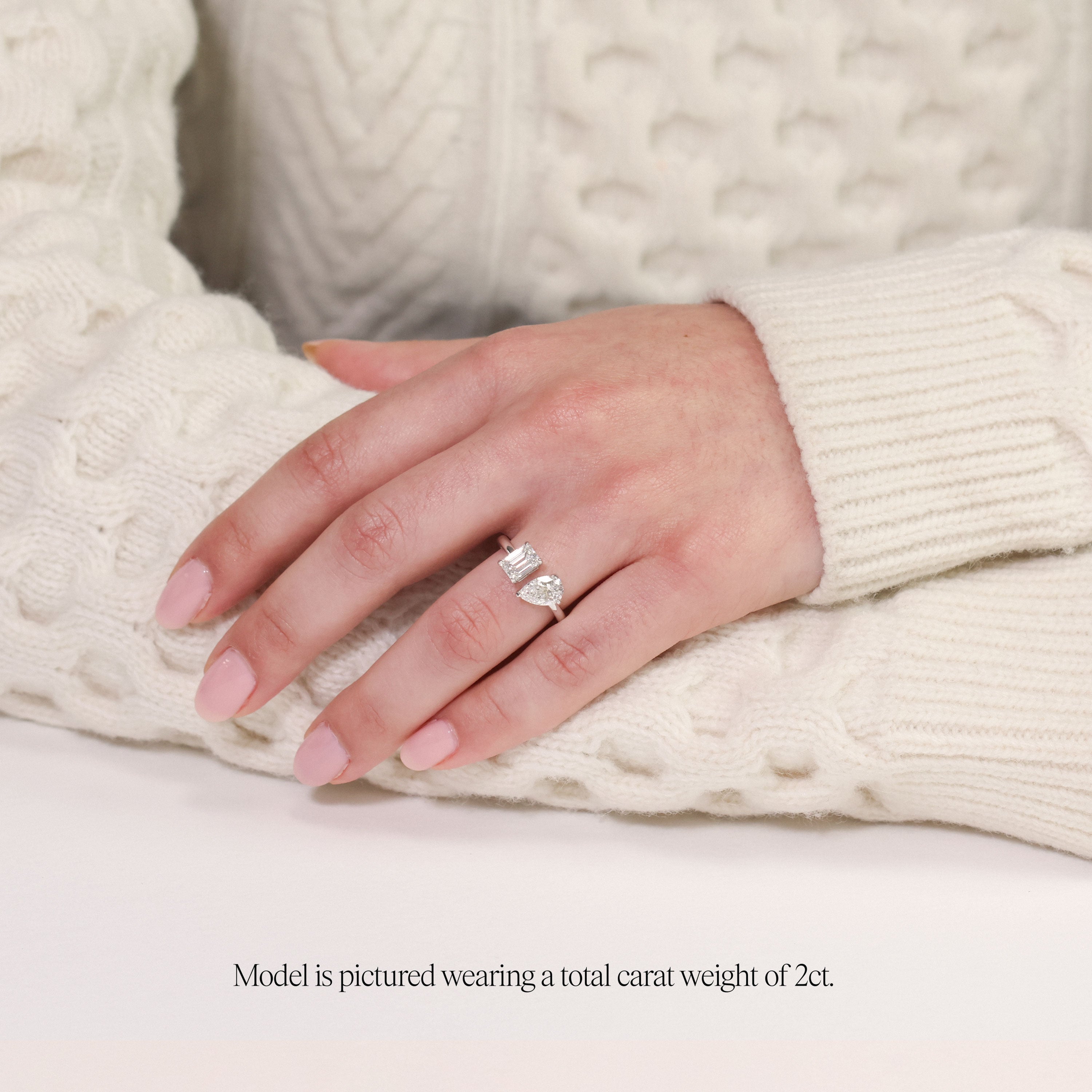 model wearing a 2 carat toi et moi ring. Lab Grown pear and emerald cut diamonds in platinum