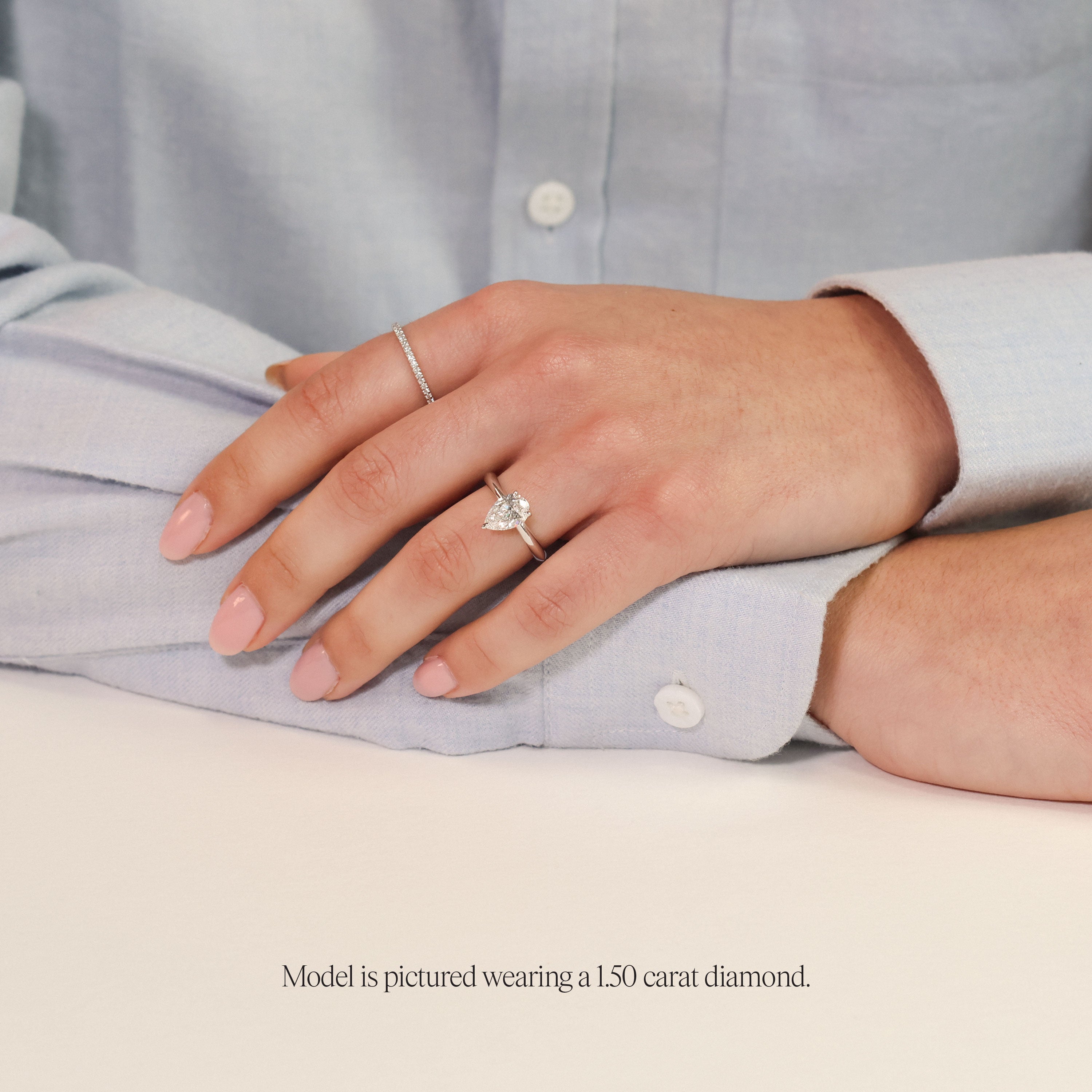 model wearing 1.5 carat pear shaped engagement ring. Pear Solitaire with lab grown diamond in platinum