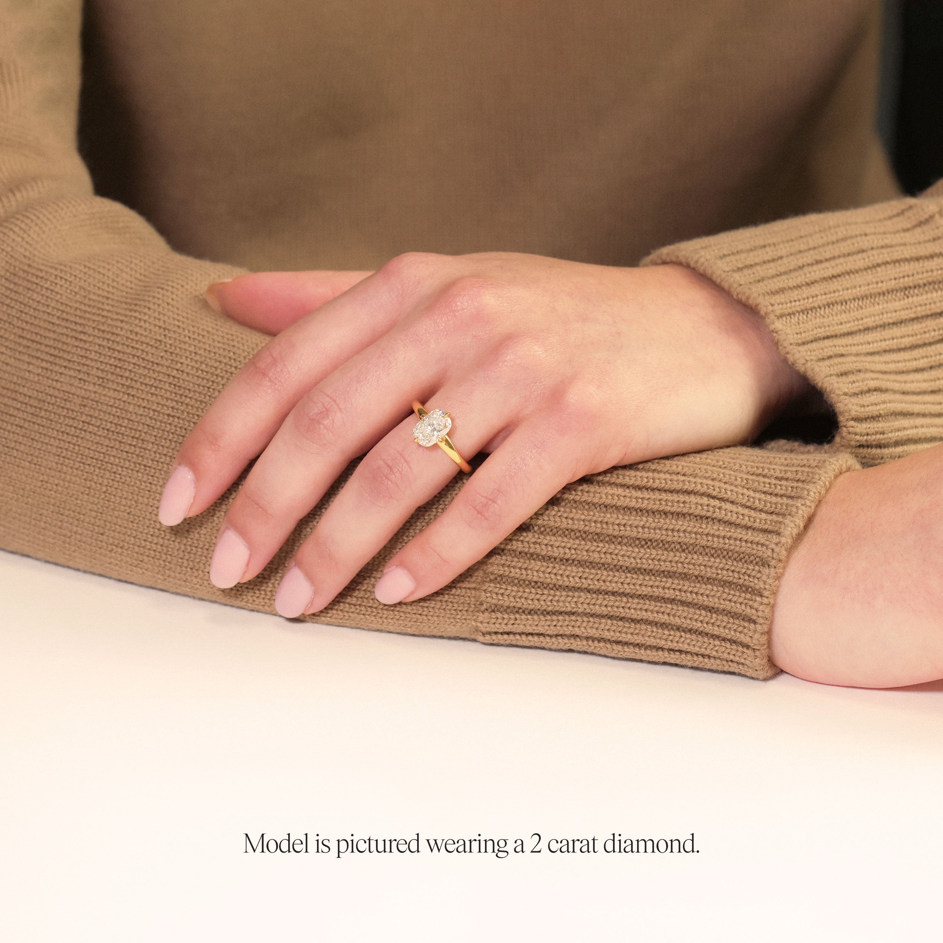 model wearing a yellow gold 2 carat Cushion cut solitaire engagement ring with lab grown diamond and compass prongs