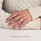 model wearing platinum oval halo engagement ring. Lab grown diamond