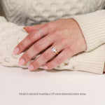 emerald cut trilogy engagement ring in yellow gold. on hand 1.5 carat lab grown diamond