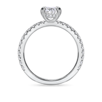side view of oval engagement ring with diamond set band and hidden halo