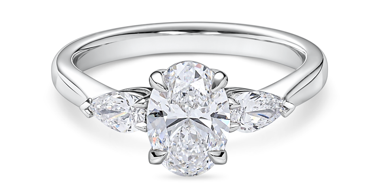 Front view of platinum oval engagement ring. Lab grown trilogy with side pears