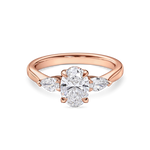 Front view of rose gold oval engagement ring. Lab grown trilogy with side pears