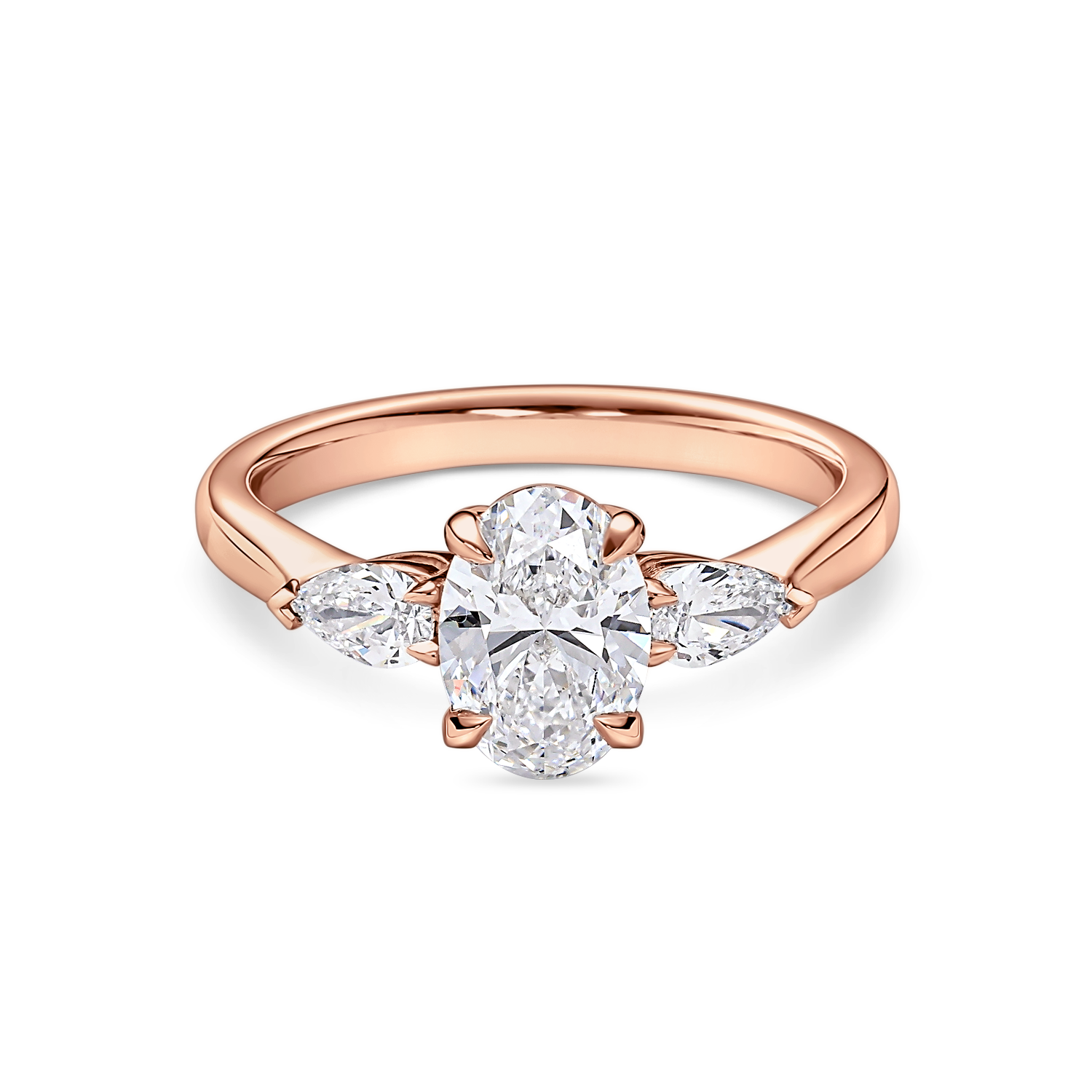 Front view of rose gold oval engagement ring. Lab grown trilogy with side pears