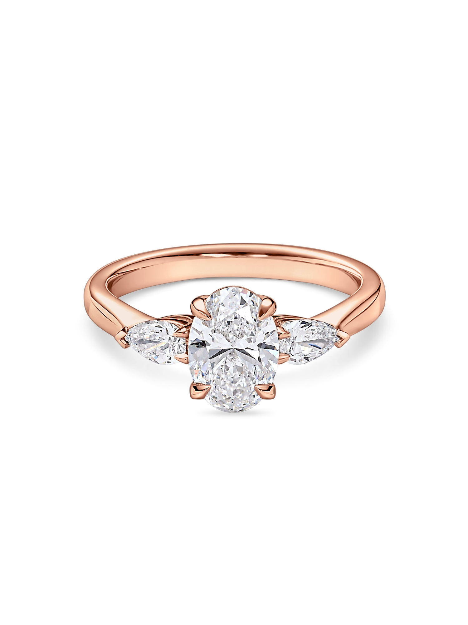 Front view of rose gold oval engagement ring. Lab grown trilogy with side pears