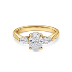 Front view of yellow gold oval engagement ring. Lab grown trilogy with side pears
