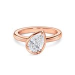 front view of the titled pear solitaire engagement ring in rose gold, featuring a lab grown diamond. 