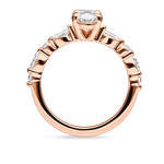 side view of unique rose gold engagement ring featuring lab grown diamonds and a diamond set band. Made in london, uk